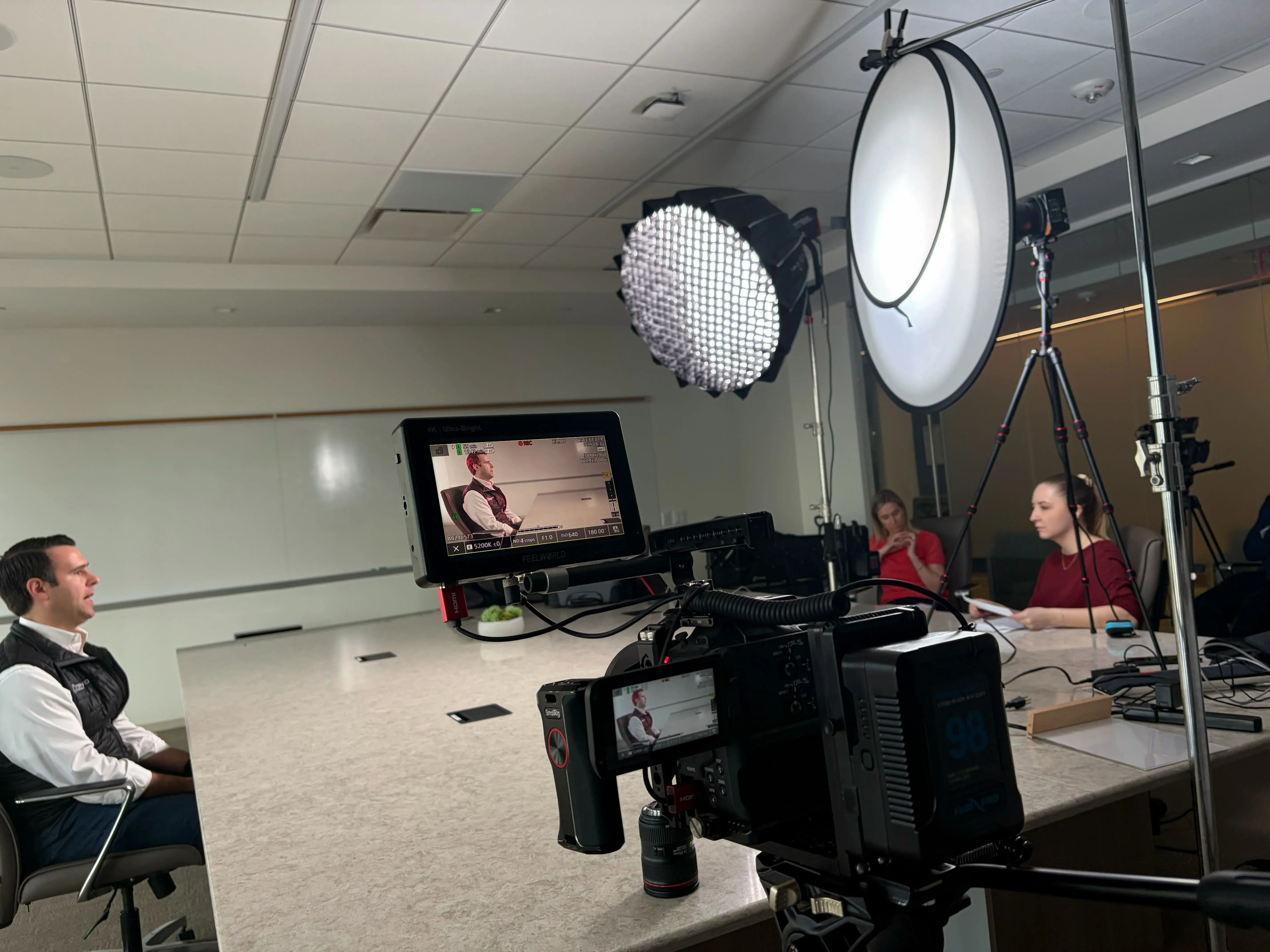 Cinema-camera interview setup with softbox lighting filming a Fervo Energy executive in a conference room by Motion Giraffx.