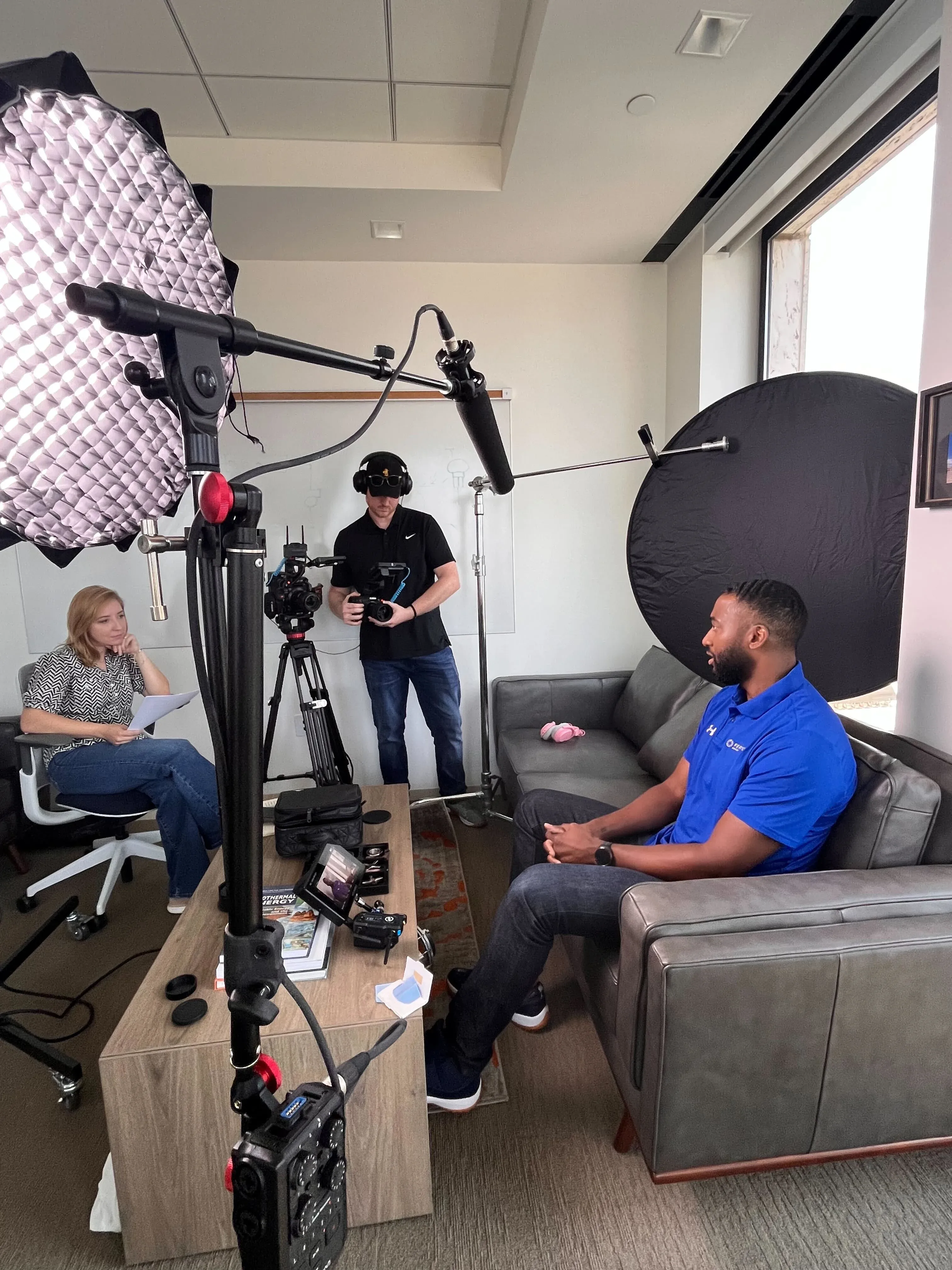 Motion Giraffx operator and producer filming a Fervo Energy team interview with full lighting kit on location.