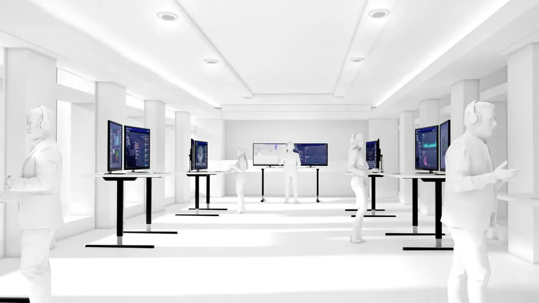 Operators in a white control room monitoring pipeline data on multiple standing workstation screens.