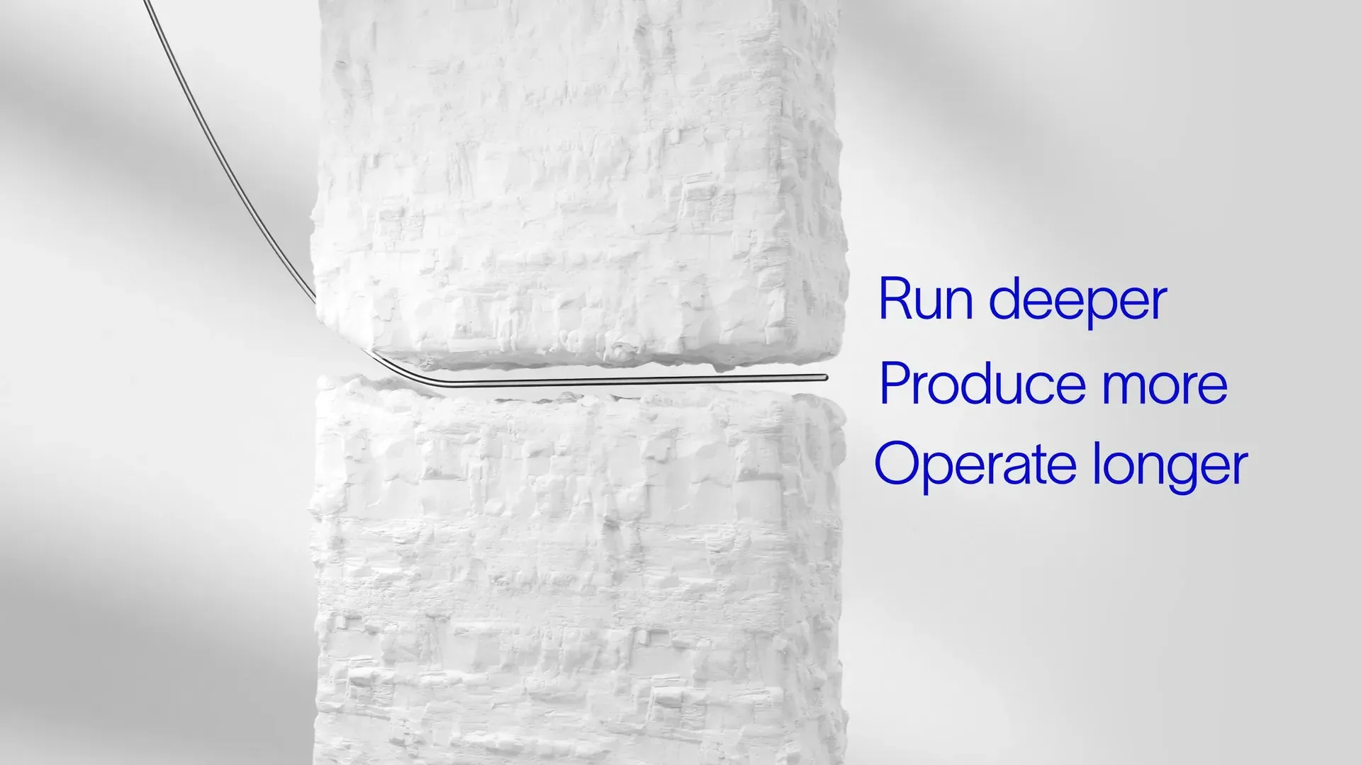 Thin pipe bending through a gap between two white rock blocks beside the on-screen text "Run deeper, Produce more, Operate longer," from the SLB Deka 3D animation by Motion Giraffx